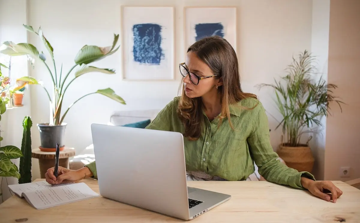 A principal product manager working on her laptop in her home office.