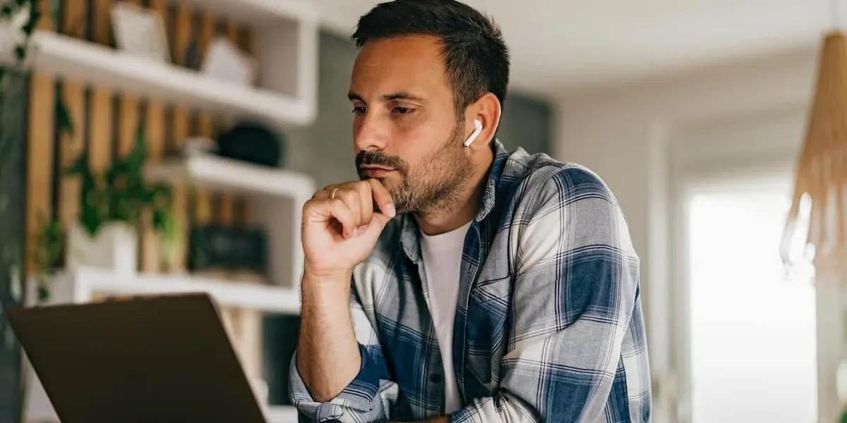 A data scientist using AI data analytics tools on his laptop.