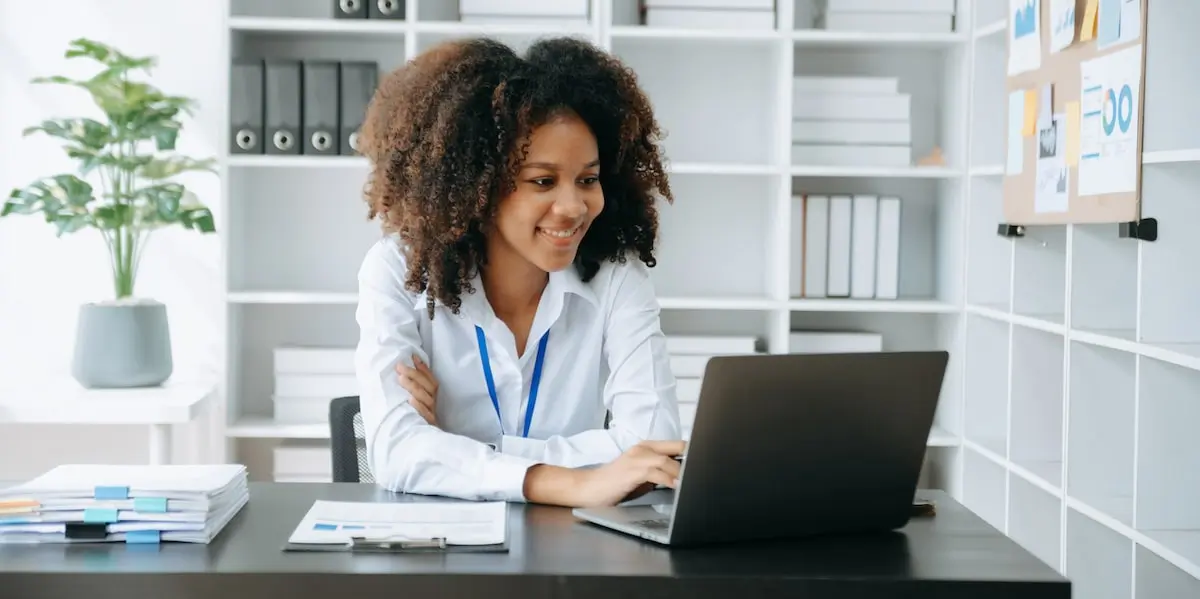 An engineer sits in her bright office applying big data analytics to a project.