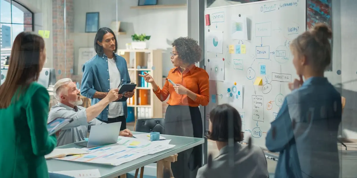 A product manager presenting a burndown chart to her whole team in an office.