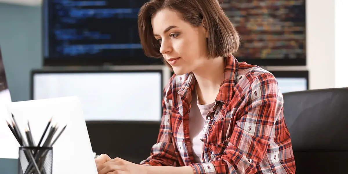 A developer sits in her office using javascript frameworks in her code.