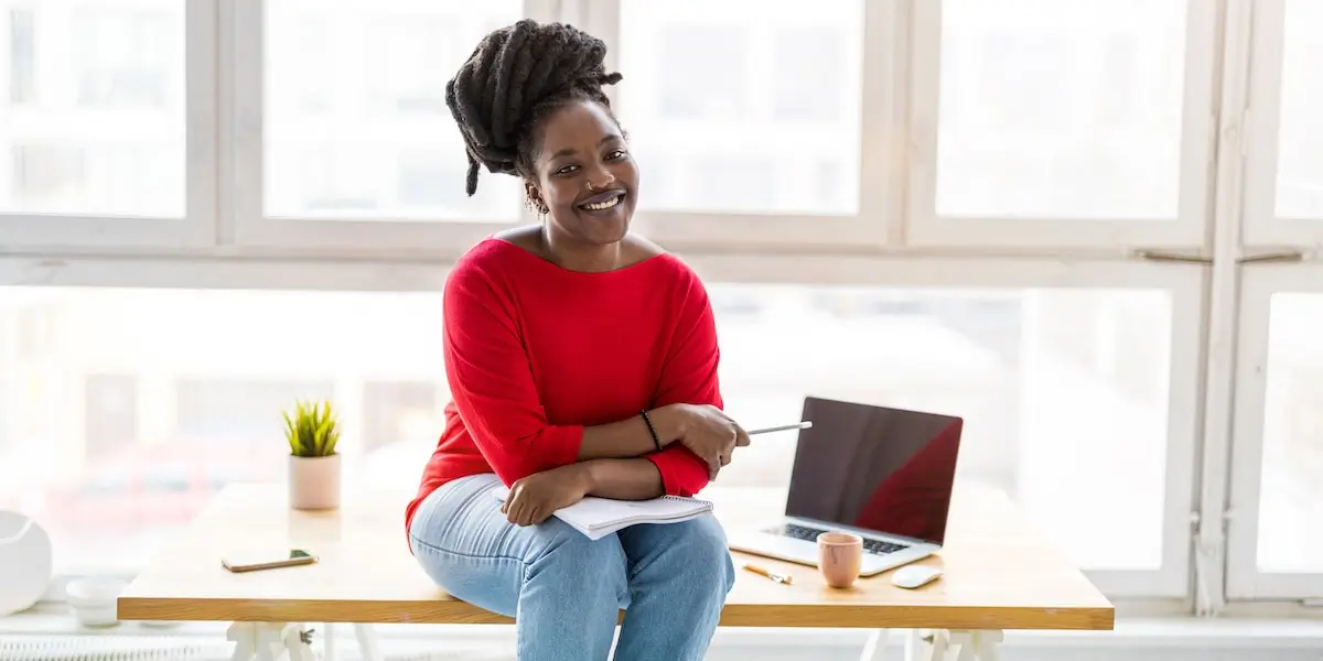 a young expat in germany sits on her desk