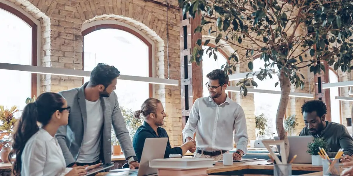 Group of colleagues discussing bias in machine learning in an office.