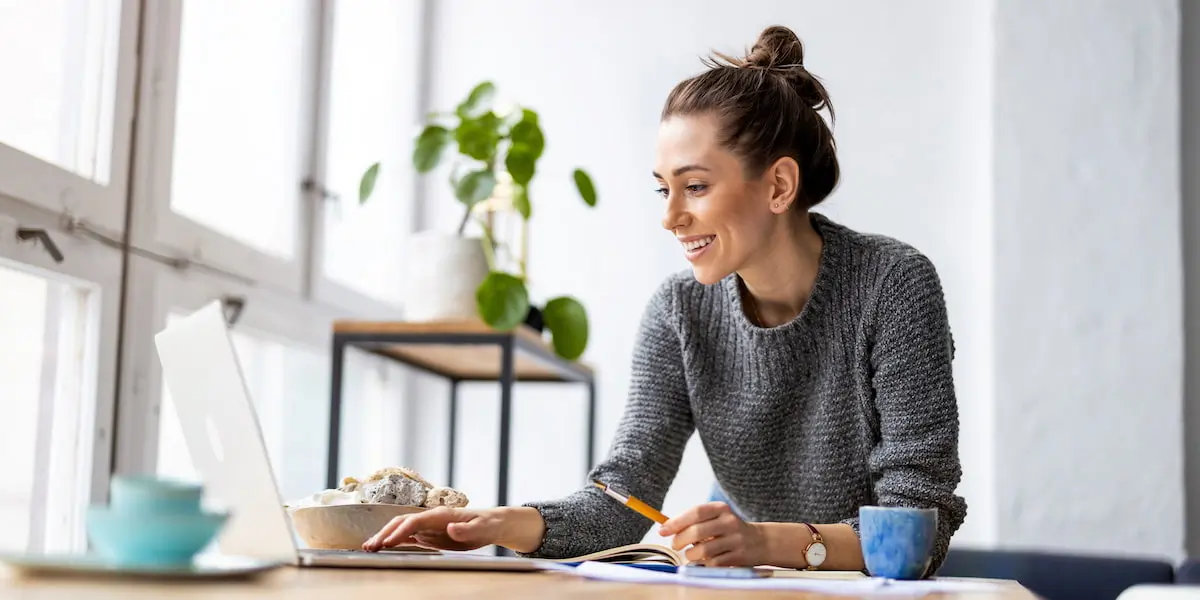 A digital marketer sits inside at her computer using chatGPT