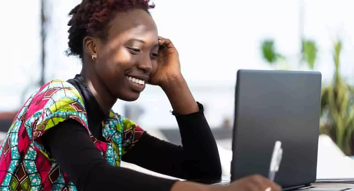 A data engineer keeping up with data trends on her laptop.